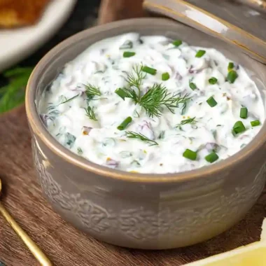 Healthy Tartar Sauce served in a ceramic bowl garnished with fresh dill and chives
