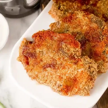 Golden, crispy Air Fryer chicken fried steak served on a white plate with creamy gravy on the side.