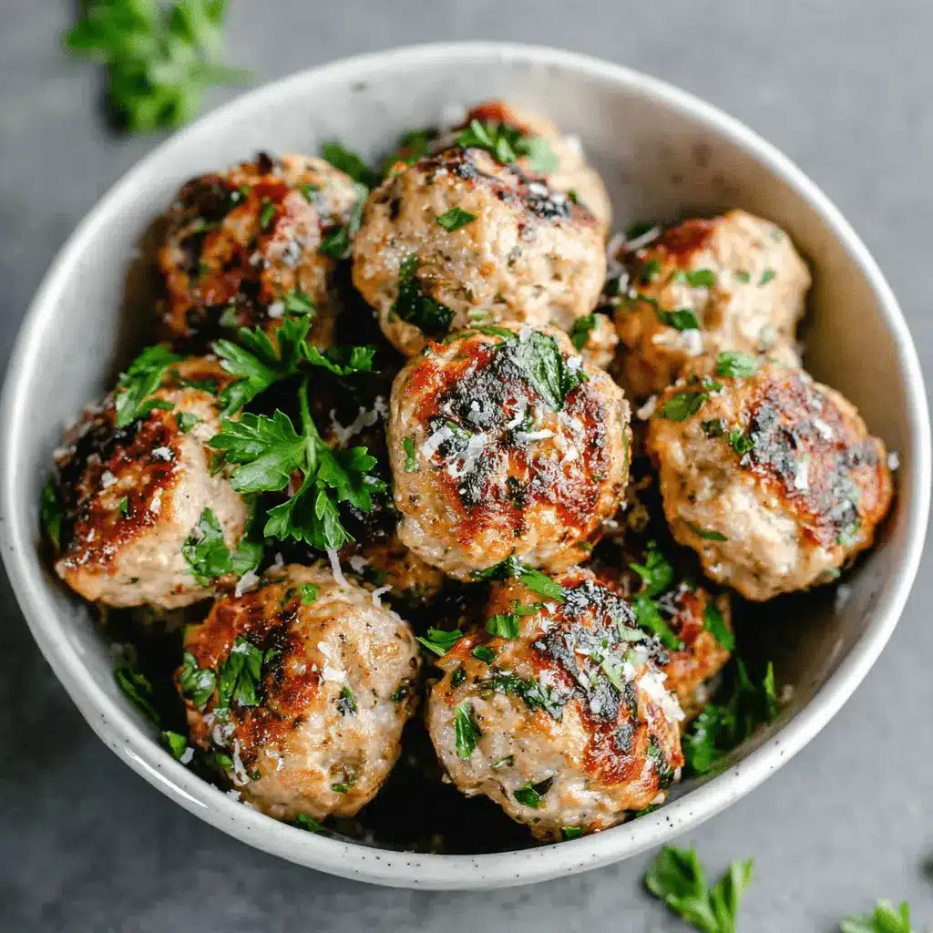 The Ultimate Turkey Meatballs Recipe 2 Close-up of savory Turkey Meatballs garnished with fresh parsley and grated cheese in a rustic bowl.