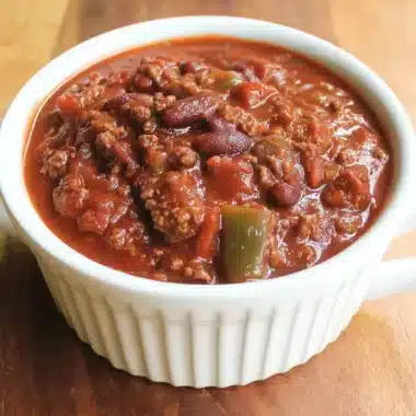 Hearty bowl of homemade chili with ground beef, kidney beans, and green bell peppers, reminiscent of a delicious wendys chili recipe, served in a white ramekin.