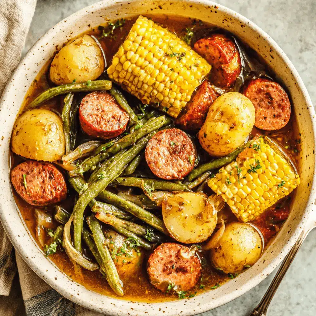 Hearty stew of new potatoes, corn, sausage, and green beans served from a swamp potatoes crockpot.