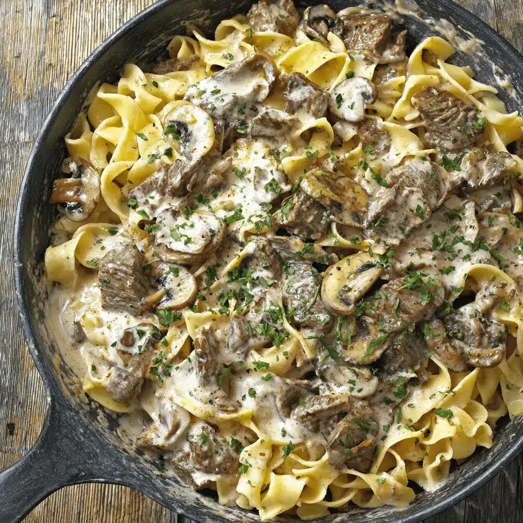 The Ultimate Prime Rib Stroganoff Recipe 2 Hearty Prime Rib Stroganoff served in a rustic cast iron skillet, featuring thick cuts of beef, egg noodles, and a rich, creamy sauce.