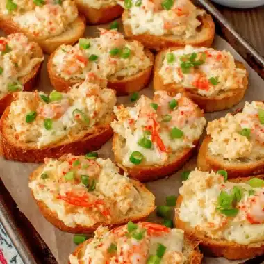 Sensational Crispy Shrimp Toast Recipe 3 Close-up of golden-brown baguette slices arranged on a baking sheet, generously topped with creamy shrimp toast mixture and fresh green onions.