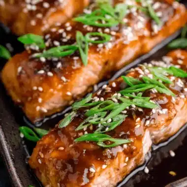 Easy 20-Minute Teriyaki Salmon Recipe 4 Close-up of perfectly glazed Teriyaki Salmon fillets garnished with sesame seeds and green onions.