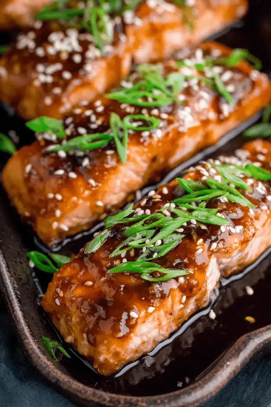 Easy 20-Minute Teriyaki Salmon Recipe 2 Close-up of perfectly glazed Teriyaki Salmon fillets garnished with sesame seeds and green onions.