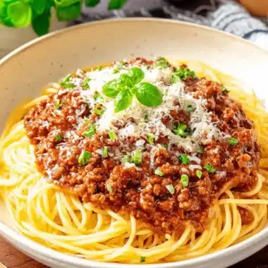 Ultimate Spaghetti Recipes with Ground Beef 3 Bowl of al dente spaghetti covered in a rich tomato and ground meat sauce, perfect for trying new spaghetti recipes with ground beef.