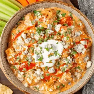 The Ultimate Buffalo Chicken Chili Recipe 3 Overhead view of creamy Buffalo Chicken Dip with blue cheese crumbles and hot sauce, offering the intense flavor profile expected from buffalo chicken chili.