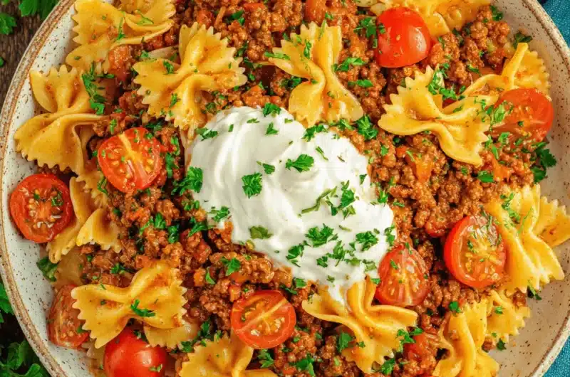 Hearty farfalle pasta with seasoned ground meat, cream, and herbs, showcasing the rich flavors of anna paul turkish pasta.
