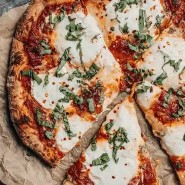 Amazing Sourdough Pizza Crust Recipe: Master Any Method 3 Sliced Margherita pizza showcasing a perfect, charred crust, the delicious result of following the Sourdough Pizza Crust Recipe.