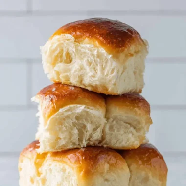 Ultimate Sourdough Hawaiian Rolls 4 Freshly baked stack of golden Sourdough Hawaiian Rolls showing a soft, airy crumb structure.