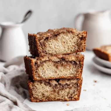 Amazing Snickerdoodle Banana Bread Recipe 4 Overhead shot of three stacked slices of homemade snickerdoodle banana bread with a rich cinnamon-sugar crumb topping.