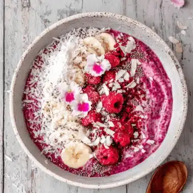 The Ultimate Raspberry Vanilla Chia Pudding 3 Vibrant overhead shot of a healthy bowl topped with fresh raspberries and chia seeds, a perfect example of a raspberry vanilla chia pudding.