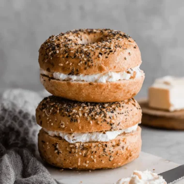 Ultimate Easy Protein Bagels with Greek Yogurt 3 Stacked everything-seasoned protein bagels with greek yogurt recipe, generously filled with cream cheese.