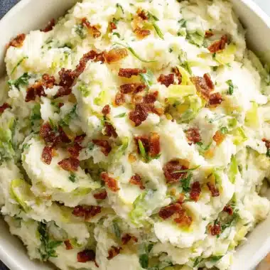Amazing Colcannon Recipe: Irish Comfort in a Bowl 4 Overhead view of a creamy, homemade colcannon recipe topped with crispy bacon crumbles and fresh scallions.