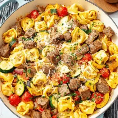 Ultimate Garlic Steak Tortellini in 30 Minutes 4 Hearty skillet of garlic steak tortellini mixed with cherry tomatoes, zucchini, and fresh Parmesan cheese.