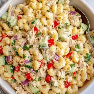 Ultimate Foolproof Tuna Pasta Salad Recipes 4 Close-up of a vibrant elbow macaroni pasta salad with creamy dressing, bell peppers, cucumber, and parsley, ideal for delicious tuna pasta salad recipes.