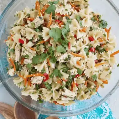 Amazing Asian Pasta Salad: Quick & Flavorful 4 Vibrant asian pasta salad with bowtie pasta, shredded chicken, carrots, and fresh cilantro.