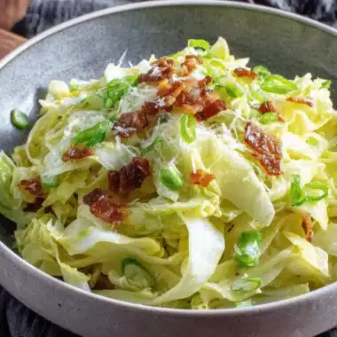Amazing Cabbage Dumplings: Simple & Quick Meal 4 Shredded cabbage dish with crispy bacon, green onions, and cheese, a perfect side for cabbage dumplings.
