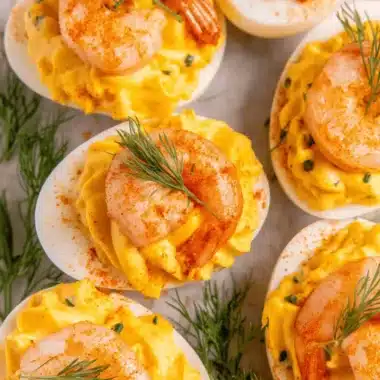 Amazing Foolproof Deviled Eggs: Classic Recipe 3 Overhead close-up of gourmet deviled eggs garnished with pink shrimp and fresh dill.