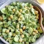 Amazing Cucumber Chickpea Salad Recipe 8 Creamy cucumber chickpea salad with fresh dill in a rustic gray bowl on a distressed white wood background.