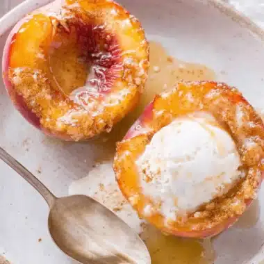 Amazing Baked Peaches: Quick & Easy Dessert 4 Delicious baked peaches with caramelized edges and melting ice cream in a rustic bowl.