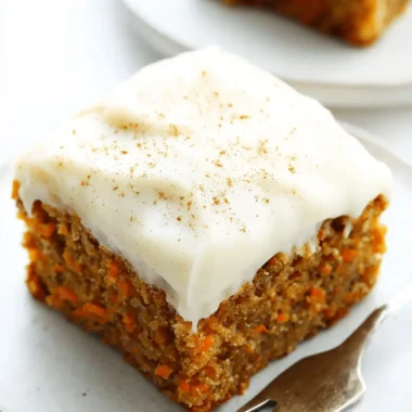 Wonderful Foolproof Carrot Cake Bars 4 Delicious square slice of moist Carrot Cake Bars with creamy white frosting and a spice dusting, served on a gray plate.