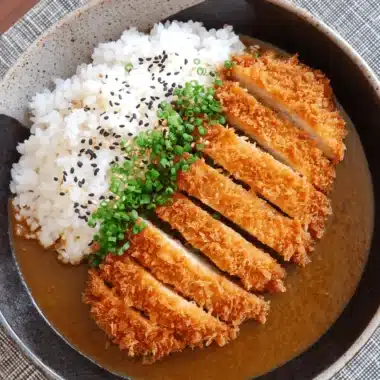 The Ultimate Crispy Chicken Katsu Recipe 4 Overhead view of a delicious Japanese katsu curry with golden-brown chicken katsu, fluffy rice, and rich curry sauce, perfect for a chicken katsu recipe.