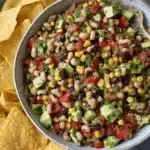 Amazing Vegan Cowboy Caviar for a Quick Feast 6 Vibrant vegan cowboy caviar with black beans, corn, avocado, and tortilla chips.