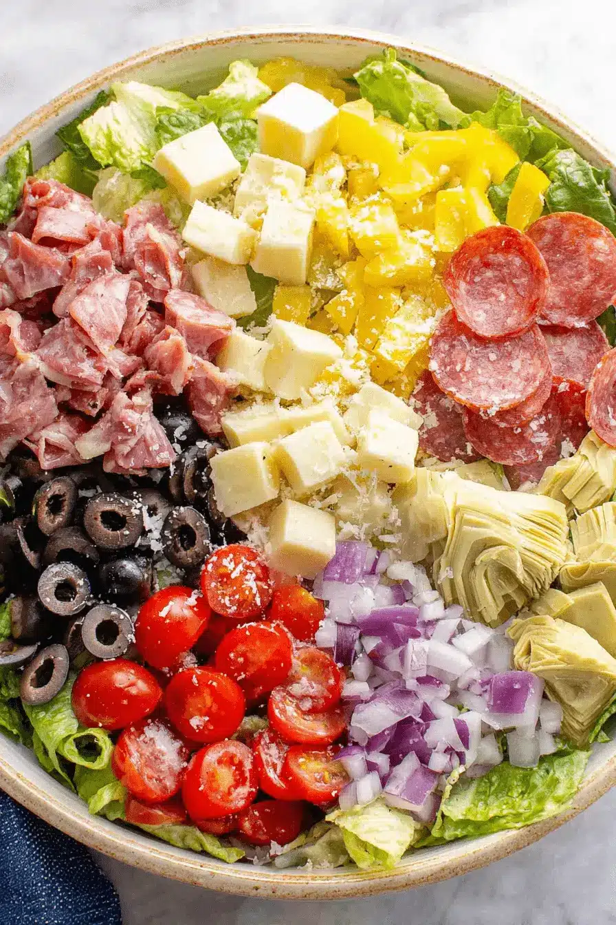 Amazing Antipasto Salad: Quick & Easy Recipe 2 Colorful and fresh antipasto salad with an array of cured meats, cheeses, and crisp vegetables.