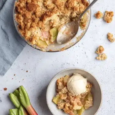Amazing Foolproof Rhubarb Crumble 4 Delicious rhubarb crumble with a golden topping, served with creamy vanilla ice cream and fresh rhubarb stalks.