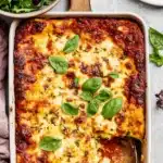 Ultimate Foolproof Zucchini Lasagna Recipe 5 Freshly baked zucchini lasagna recipe, golden brown with bubbly cheese and fresh basil, served in a white baking dish.