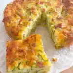 The Ultimate Foolproof Zucchini Slice 6 Delectable golden brown zucchini and ham quiche, with a perfect zucchini slice removed and ready to enjoy.