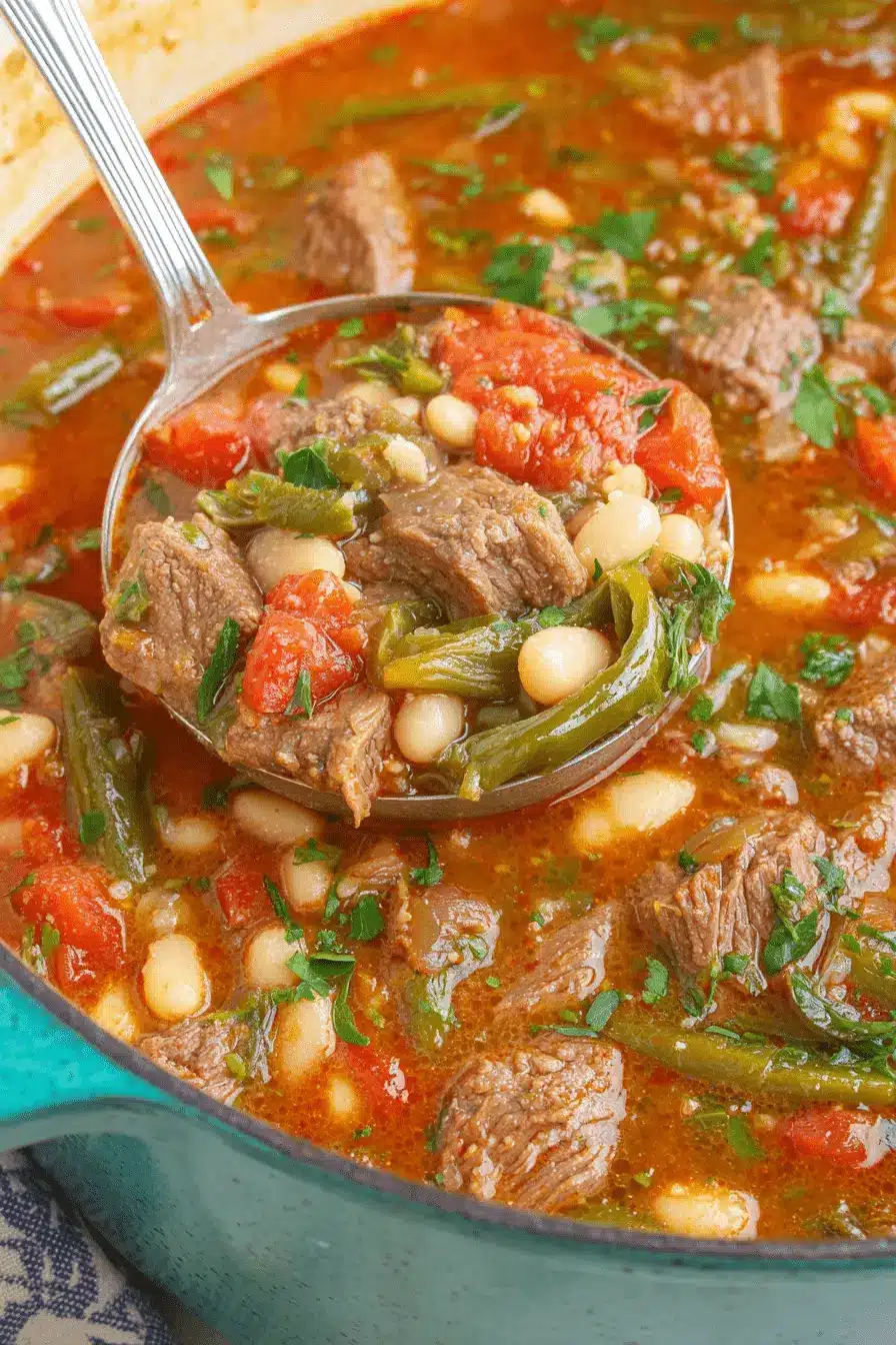 The Ultimate Hatch Green Chili Stew Recipe 2 Ladle serving hearty hatch green chili stew with beef, white beans, green beans, and tomatoes from a teal pot.