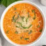 Amazing Roasted Cherry Tomato Soup 5 Creamy cherry tomato soup in a white bowl, garnished with Parmesan and fresh basil.