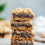 Amazing Homemade Fig Bars: Simple Recipe 5 Delicious stacked homemade fig bars with an oatmeal crumble topping and rich fig filling on a neutral background.