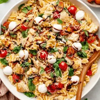 The Ultimate Chicken Caprese Pasta Salad 4 Delicious chicken Caprese pasta salad with grilled chicken, cherry tomatoes, mozzarella, and balsamic glaze.
